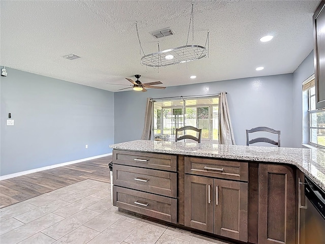 11340 Corinthian St, Spring Hill, FL 34609 - kitchen featuring dishwasher, ceiling fan, recessed lighting, a textured ceiling, and light stone countertops