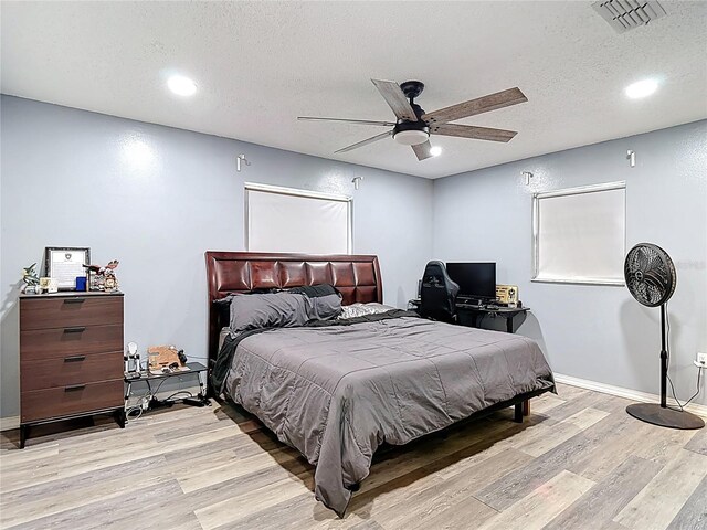 11340 Corinthian St, Spring Hill, FL 34609 - bedroom featuring a textured ceiling, light wood-style flooring, ceiling fan, recessed lighting, and baseboards