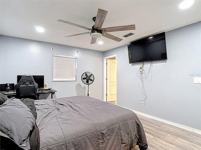 11340 Corinthian St, Spring Hill, FL 34609 - bedroom with light wood-style flooring, recessed lighting, a textured ceiling, a ceiling fan, and baseboards