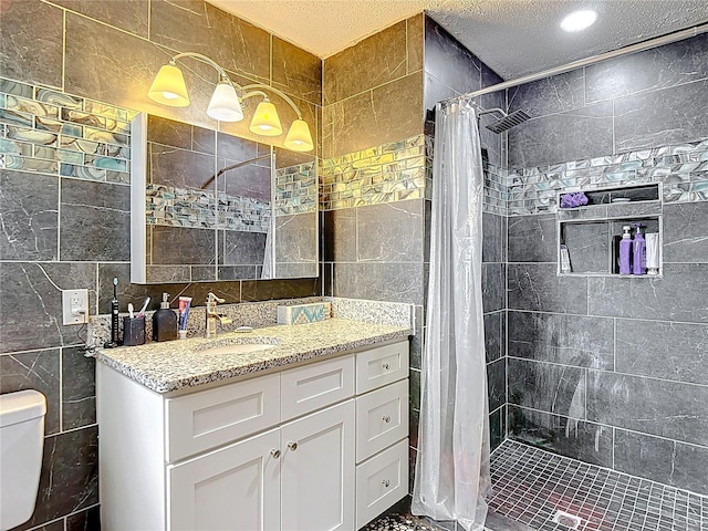 11340 Corinthian St, Spring Hill, FL 34609 - bathroom with tile walls, toilet, vanity, tiled shower, and a textured ceiling