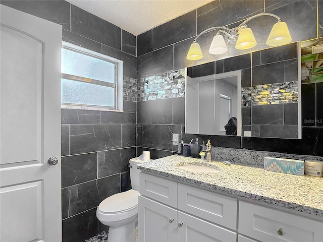 11340 Corinthian St, Spring Hill, FL 34609 - bathroom featuring tile walls, vanity, toilet, and tasteful backsplash