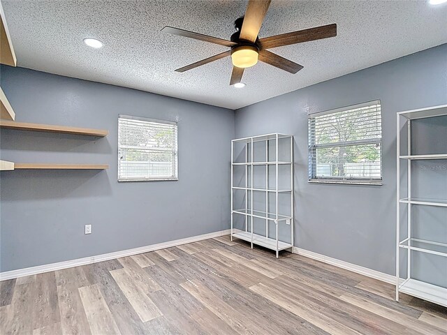 11340 Corinthian St, Spring Hill, FL 34609 - unfurnished room with wood finished floors, a ceiling fan, a textured ceiling, baseboards, and recessed lighting