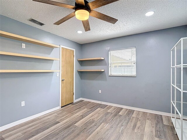 11340 Corinthian St, Spring Hill, FL 34609 - unfurnished bedroom featuring wood finished floors, a textured ceiling, recessed lighting, baseboards, and ceiling fan