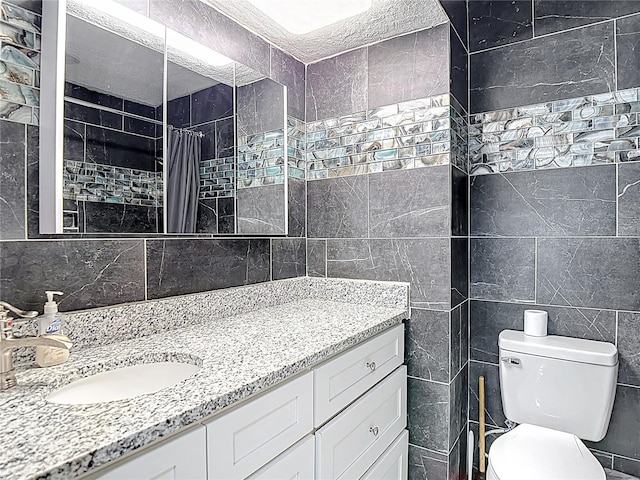 11340 Corinthian St, Spring Hill, FL 34609 - full bathroom featuring tile walls, vanity, toilet, a tile shower, and tasteful backsplash