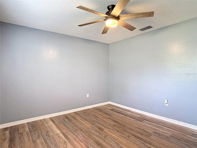 11340 Corinthian St, Spring Hill, FL 34609 - unfurnished room featuring a ceiling fan, wood finished floors, baseboards, and a textured ceiling