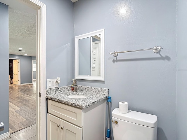 11340 Corinthian St, Spring Hill, FL 34609 - half bath featuring vanity, toilet, and a textured ceiling