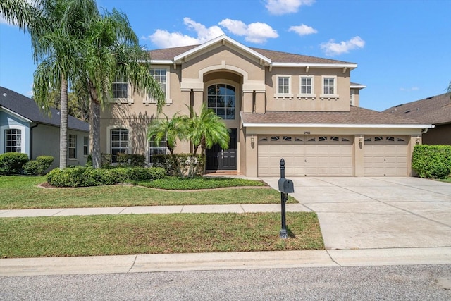 17905 Machair Ln, Land O Lakes, FL 34638 - view of front of house featuring driveway, stucco siding, a front lawn, and an attached garage