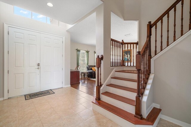 17905 Machair Ln, Land O Lakes, FL 34638 - entryway with stairway, baseboards, light tile patterned floors, and recessed lighting