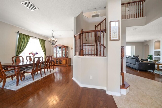 17905 Machair Ln, Land O Lakes, FL 34638 - dining area with stairway, hardwood / wood-style flooring, plenty of natural light, and a chandelier