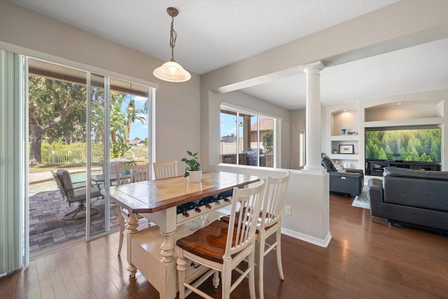 17905 Machair Ln, Land O Lakes, FL 34638 - dining space featuring decorative columns and hardwood / wood-style floors
