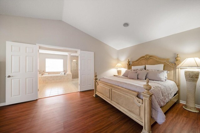 17905 Machair Ln, Land O Lakes, FL 34638 - bedroom with decorative columns, lofted ceiling, wood finished floors, ensuite bathroom, and baseboards