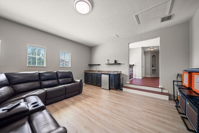 17905 Machair Ln, Land O Lakes, FL 34638 - living room featuring light wood finished floors and a textured ceiling