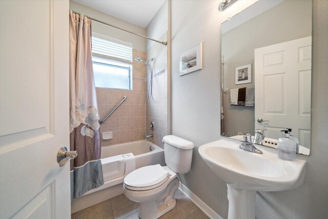 17905 Machair Ln, Land O Lakes, FL 34638 - bathroom with shower / bathtub combination with curtain, toilet, baseboards, and tile patterned flooring