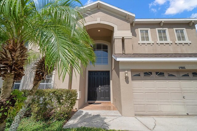 17905 Machair Ln, Land O Lakes, FL 34638 - view of front of home featuring stucco siding and a garage
