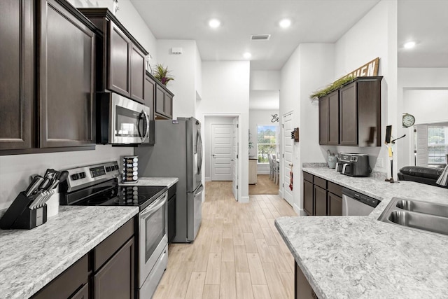 11042 Heth Ct, Weeki Wachee, FL 34613 - kitchen featuring stainless steel appliances, dark brown cabinetry, light countertops, and recessed lighting