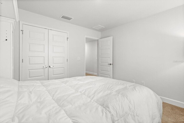 11042 Heth Ct, Weeki Wachee, FL 34613 - carpeted bedroom with a closet and baseboards