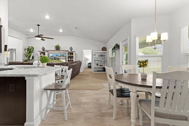 11042 Heth Ct, Weeki Wachee, FL 34613 - dining space featuring a ceiling fan, lofted ceiling, light wood-style floors, a chandelier, and recessed lighting