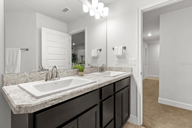 11042 Heth Ct, Weeki Wachee, FL 34613 - bathroom featuring double vanity and baseboards
