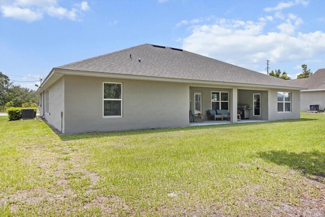 11042 Heth Ct, Weeki Wachee, FL 34613 - rear view of property with central AC unit, roof with shingles, a patio, stucco siding, and a lawn