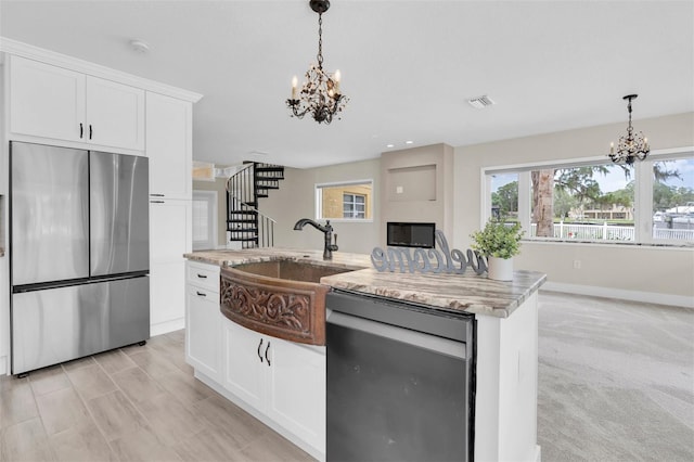 5440 Manatee Point Dr, New Port Richey, FL 34652 - kitchen with appliances with stainless steel finishes, a chandelier, a sink, hanging light fixtures, and recessed lighting