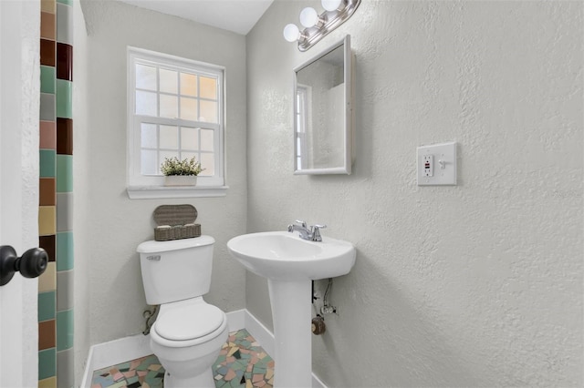 5440 Manatee Point Dr, New Port Richey, FL 34652 - bathroom featuring toilet, baseboards, and a sink
