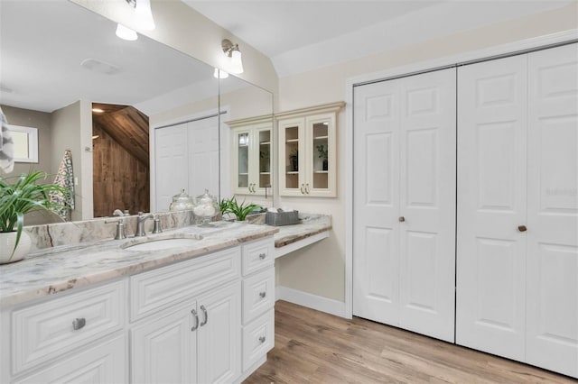 5440 Manatee Point Dr, New Port Richey, FL 34652 - full bath with a closet, vanity, wood finished floors, and baseboards