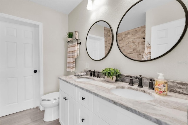 5440 Manatee Point Dr, New Port Richey, FL 34652 - full bathroom featuring double vanity, wood finished floors, toilet, and a shower