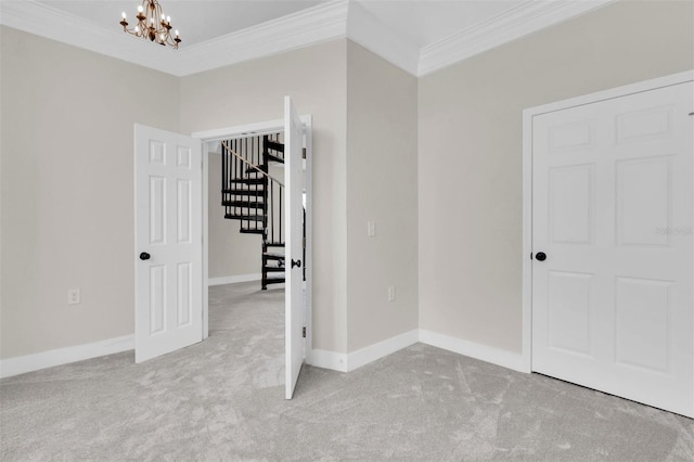 5440 Manatee Point Dr, New Port Richey, FL 34652 - carpeted empty room featuring ornamental molding, a chandelier, stairs, and baseboards