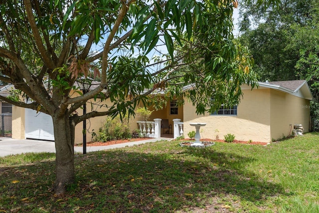 3140 Bahia Ave, Holiday, FL 34690 - view of front of house featuring stucco siding, a front yard, concrete driveway, and a shingled roof