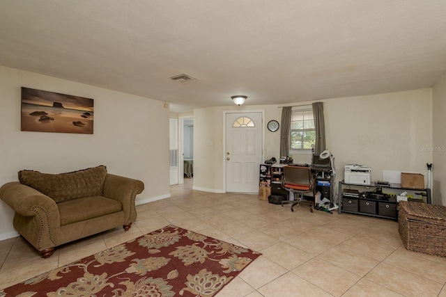 3140 Bahia Ave, Holiday, FL 34690 - living area featuring light tile patterned floors, a desk, and baseboards