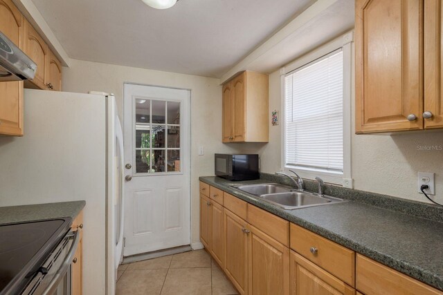3140 Bahia Ave, Holiday, FL 34690 - kitchen with a sink, black microwave, dark countertops, wall chimney range hood, and light tile patterned floors
