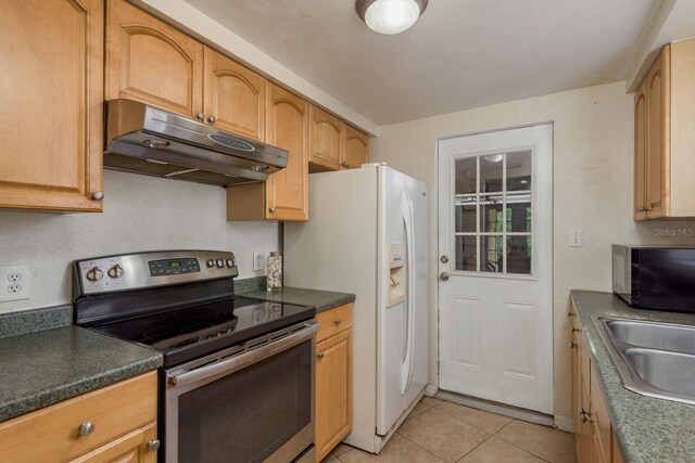 3140 Bahia Ave, Holiday, FL 34690 - kitchen featuring stainless steel electric range, under cabinet range hood, black microwave, light tile patterned floors, and dark countertops