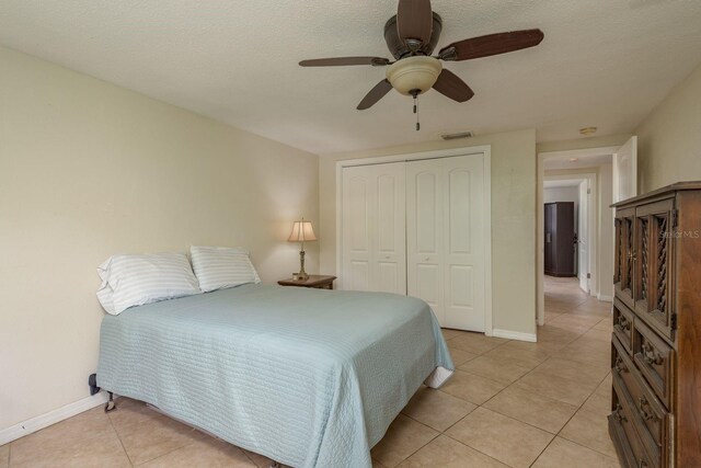 3140 Bahia Ave, Holiday, FL 34690 - bedroom featuring light tile patterned flooring, a closet, baseboards, and a ceiling fan