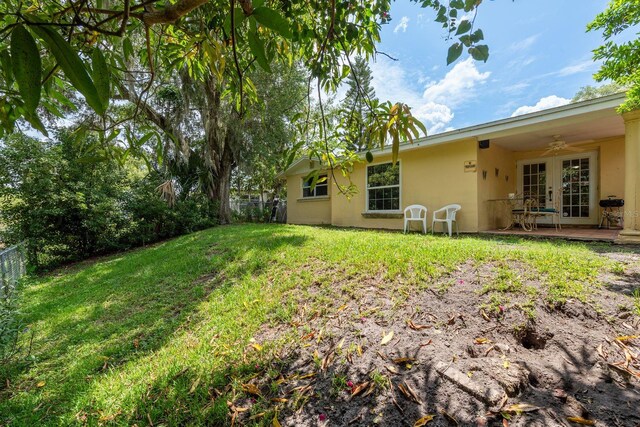 3140 Bahia Ave, Holiday, FL 34690 - view of yard with ceiling fan and french doors