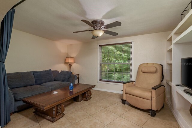 3140 Bahia Ave, Holiday, FL 34690 - living area with a ceiling fan, light tile patterned floors, and baseboards