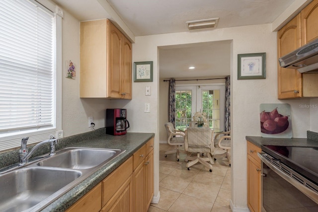 3140 Bahia Ave, Holiday, FL 34690 - kitchen featuring a sink, range with electric cooktop, dark countertops, and light tile patterned flooring