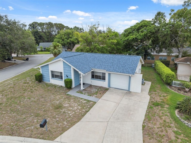 13001 Sawmill Way, Hudson, FL 34667 - ranch-style house with driveway, an attached garage, and roof with shingles