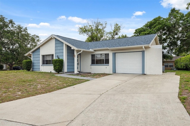 13001 Sawmill Way, Hudson, FL 34667 - view of front of property featuring a garage, driveway, a front yard, and brick siding
