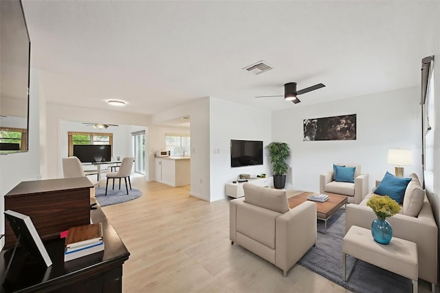 13001 Sawmill Way, Hudson, FL 34667 - living room featuring a ceiling fan and light wood-type flooring