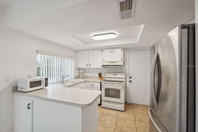 13001 Sawmill Way, Hudson, FL 34667 - kitchen with white appliances, range hood, a sink, a peninsula, and a raised ceiling