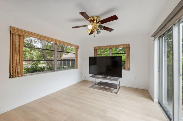 13001 Sawmill Way, Hudson, FL 34667 - living room featuring plenty of natural light, light wood finished floors, and a ceiling fan