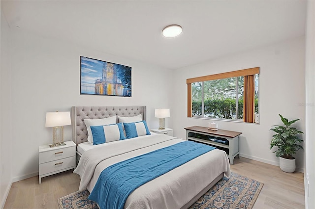 13001 Sawmill Way, Hudson, FL 34667 - bedroom with light wood-style floors and baseboards