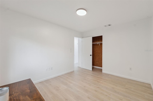13001 Sawmill Way, Hudson, FL 34667 - unfurnished bedroom with light wood-style floors, a closet, and baseboards