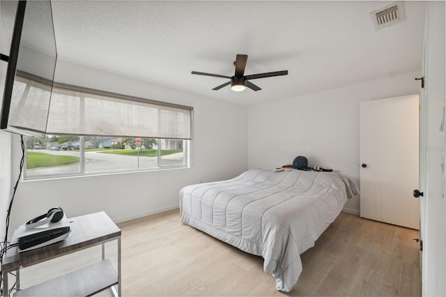 13001 Sawmill Way, Hudson, FL 34667 - bedroom featuring wood finished floors, baseboards, and ceiling fan