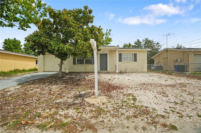 8053 Dedham Dr, Port Richey, FL 34668 - view of front of property with stucco siding, driveway, and an attached garage