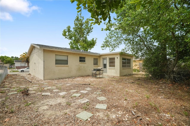 8053 Dedham Dr, Port Richey, FL 34668 - rear view of property featuring stucco siding and a patio area