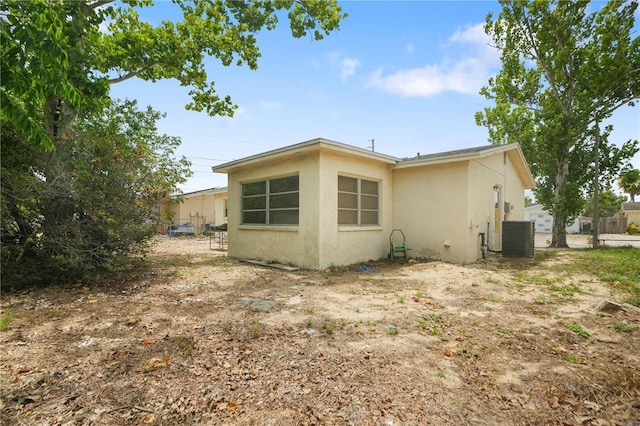 8053 Dedham Dr, Port Richey, FL 34668 - view of property exterior featuring stucco siding and central AC unit
