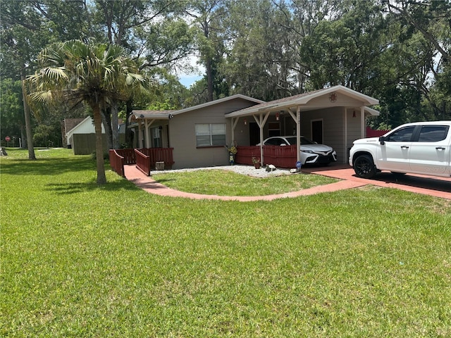 717 Whiteway Dr, Brooksville, FL 34601 - view of front of house with a front yard and an attached carport