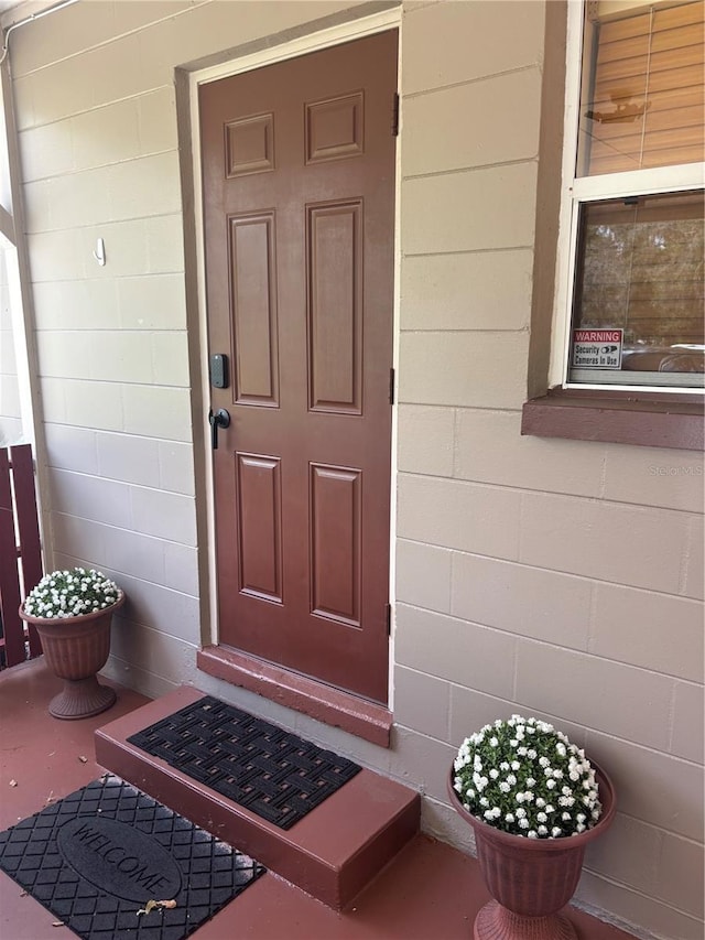 717 Whiteway Dr, Brooksville, FL 34601 - doorway to property with concrete block siding