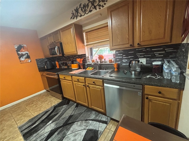 717 Whiteway Dr, Brooksville, FL 34601 - kitchen featuring stainless steel appliances, a sink, tasteful backsplash, dark countertops, and light tile patterned floors
